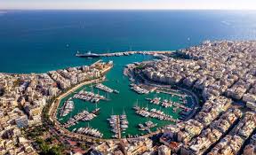 Aerial view of Zea Marina in Piraeus with yachts docked in turquoise water surrounded by the city